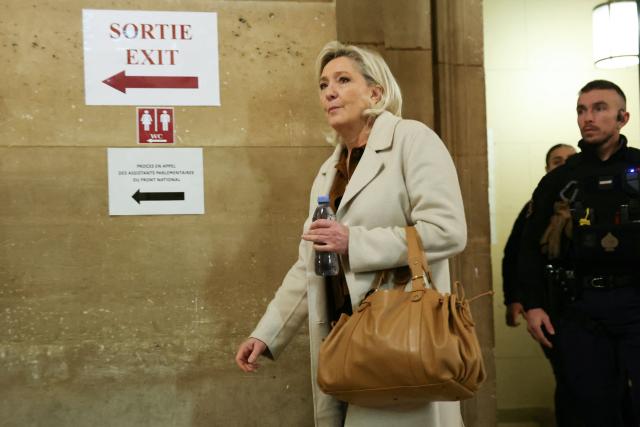 President of the parliamentary group of the French far-right Rassemblement National (RN) party, Marine Le Pen arrives for a hearing in her appeal trial on suspicion of embezzlement of European public funds, at Paris courthouse on January 15, 2026. The appeal comes after a court last year barred the President of the RN parliamentary group Marine Le Pen from running for office for five years over a European Parliament fake-jobs scam involving her and other officials from her National Rally party. The hearing is expected to run until February 11, 2026, with a decision expected this summer. Twelve of the accused, as well as the far-right party itself, have appealed against the verdict while another 12 people -- including one of Le Pen's sisters -- have decided to accept their convictions without appealing. (Photo by Alain JOCARD / AFP)