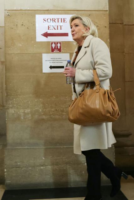 President of the parliamentary group of the French far-right Rassemblement National (RN) party, Marine Le Pen arrives for a hearing in her appeal trial on suspicion of embezzlement of European public funds, at Paris courthouse on January 15, 2026. The appeal comes after a court last year barred the President of the RN parliamentary group Marine Le Pen from running for office for five years over a European Parliament fake-jobs scam involving her and other officials from her National Rally party. The hearing is expected to run until February 11, 2026, with a decision expected this summer. Twelve of the accused, as well as the far-right party itself, have appealed against the verdict while another 12 people -- including one of Le Pen's sisters -- have decided to accept their convictions without appealing. (Photo by Alain JOCARD / AFP)