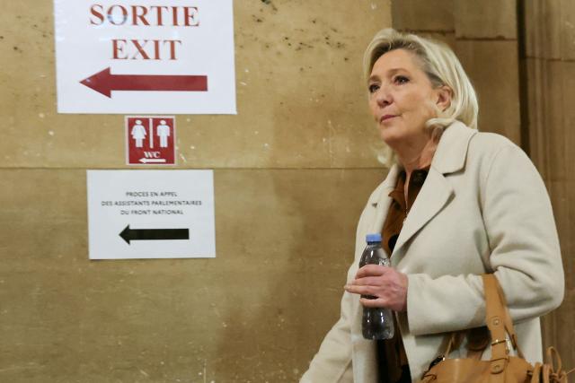 President of the parliamentary group of the French far-right Rassemblement National (RN) party, Marine Le Pen arrives for a hearing in her appeal trial on suspicion of embezzlement of European public funds, at Paris courthouse on January 15, 2026. The appeal comes after a court last year barred the President of the RN parliamentary group Marine Le Pen from running for office for five years over a European Parliament fake-jobs scam involving her and other officials from her National Rally party. The hearing is expected to run until February 11, 2026, with a decision expected this summer. Twelve of the accused, as well as the far-right party itself, have appealed against the verdict while another 12 people -- including one of Le Pen's sisters -- have decided to accept their convictions without appealing. (Photo by Alain JOCARD / AFP)