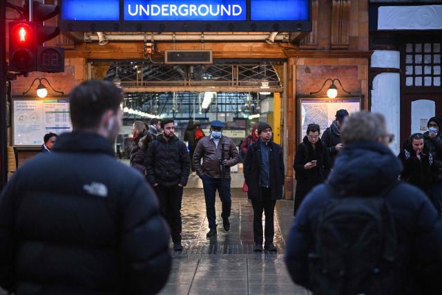 Pedestrians wait for the light to change to cross the street outside Earls Court station in London on January 15, 2026. Britain's economy grew more than expected in November, official data showed on January 15, handing a boost to the Labour government after recent weak figures. (Photo by JUSTIN TALLIS / AFP)