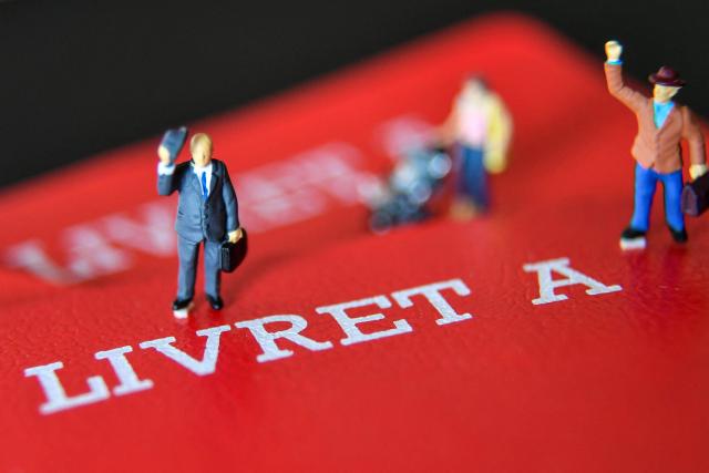 (FILES) This photograph taken on April 19, 2023 in Lille, northern France, shows figurines displayed on Livret A savings books. The Governor of the Bank of France proposed on January 15, 2026 to lower the Livret A rate to 1.5%, down from the current 1.7%, and to set the rate for the Livret d'épargne populaire, reserved for low-income savers, at 2.5%. (Photo by DENIS CHARLET / AFP)