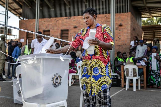 A voter casts her ballot at a school used as a polling station in Kampala on January 15, 2026, during Uganda’s 2026 general elections. (Photo by Luis TATO / AFP)