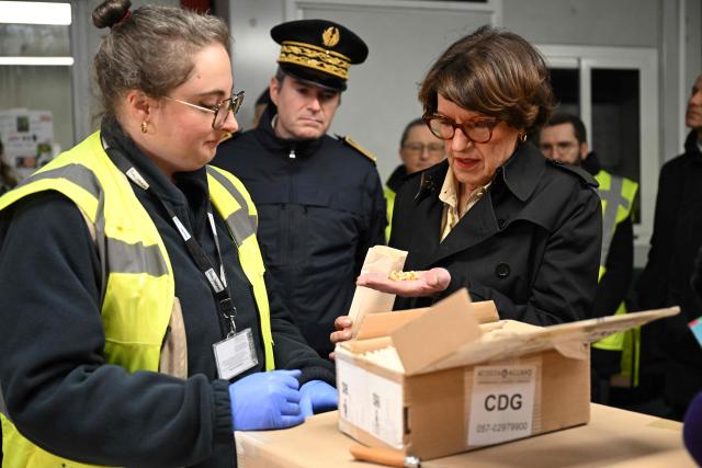France's Agriculture Minister Annie Genevard speaks with employees of French Customs as she attends an inspection of imported foodstuffs at Roissy Charles-de-Gaulle airport in Paris, on January 15, 2026. (Photo by Bertrand GUAY / AFP)