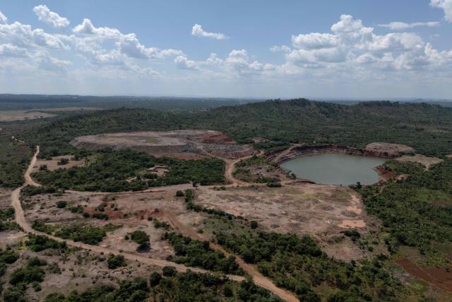 This aerial view shows a mining site next to a forest reserve in Likasi on November 27, 2025. As Chinese, US and other companies jostle over DR Congo’s critical minerals, communities in Haut-Katanga province fear security restrictions or unannounced road constructions in reserves will increase as they seek to protect their land. (Photo by Glody MURHABAZI / AFP)