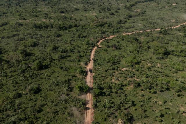 This aerial view shows road in a forest area in Likasi on November 27, 2025. As Chinese, US and other companies jostle over DR Congo’s critical minerals, communities in Haut-Katanga province fear security restrictions or unannounced road constructions in reserves will increase as they seek to protect their land. (Photo by Glody MURHABAZI / AFP)
