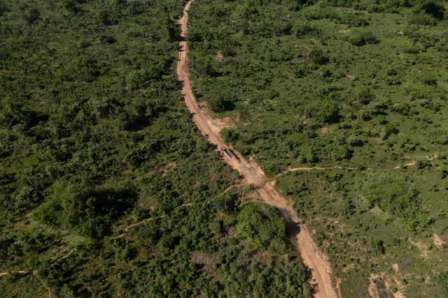 This aerial view shows road in a forest area in Likasi on November 27, 2025. As Chinese, US and other companies jostle over DR Congo’s critical minerals, communities in Haut-Katanga province fear security restrictions or unannounced road constructions in reserves will increase as they seek to protect their land. (Photo by Glody MURHABAZI / AFP)
