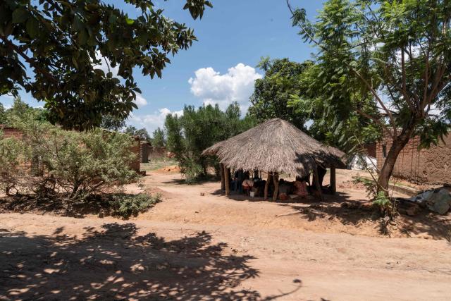A general view of a thatched roof structure next to the road in Likasi on November 27, 2025. As Chinese, US and other companies jostle over DR Congo’s critical minerals, communities in Haut-Katanga province fear security restrictions or unannounced road constructions in reserves will increase as they seek to protect their land. (Photo by Glody MURHABAZI / AFP)