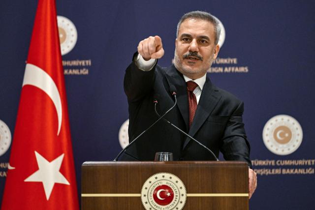 Turkish Minister of Foreign Affairs Hakan Fidan gestures as he addresses the audience during a press briefing meeting to review the past year and to share insights regarding regional and global developments in Istanbul, on January 15, 2026. Turkey's top diplomat called on January 15, 2026 for dialogue to the crisis in Iran, rocked by mass protests which rights group say have left thousands dead and which prompted US warnings to Tehran. (Photo by Ozan KOSE / AFP)