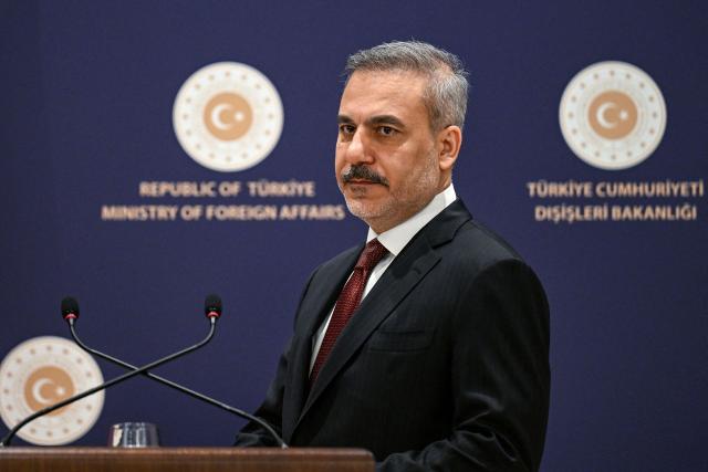 Turkish Minister of Foreign Affairs Hakan Fidan looks on as he addresses the audience during a press briefing meeting to review the past year and to share insights regarding regional and global developments in Istanbul, on January 15, 2026. Turkey's top diplomat called on January 15, 2026 for dialogue to the crisis in Iran, rocked by mass protests which rights group say have left thousands dead and which prompted US warnings to Tehran. (Photo by Ozan KOSE / AFP)