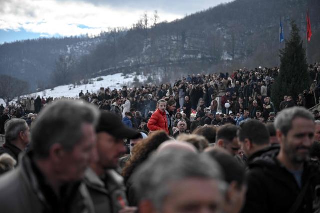 Kosovo Albanians take part in a ceremony in tribute to the victims of the Racak massacre in the village of Racak on January 15, 2026, marking the 27th anniversary of the event where forty-five Albanian civilians were killed by Serb forces during the Kosovo war in 1999. (Photo by Armend NIMANI / AFP)
