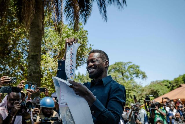 Uganda opposition leader and National Unity Platform (NUP) presidential candidate Robert Kyagulanyi Ssentamu, popularly known as Bobi Wine, shows his ballot before casting it in Kampala on January 15, 2026, during Uganda’s 2026 general elections. (Photo by Rian COPE / AFP)