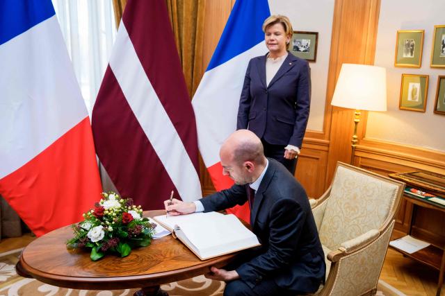 France's Foreign Affairs Minister, Minister for Europe Jean-Noel Barrot (front) signs the official guestbook before a meeting Latvian Foreign Minister Baiba Braze (back) at the Ministry of Foreign Affairs in Riga, Latvia, on January 15, 2026. The visit of France's Foreign Affairs Minister, Minister for Europe marks the occasion of the 105th anniversary of de iure recognition of the Republic of Latvia by the international community on January 26, 2026. (Photo by Gints Ivuskans / AFP)