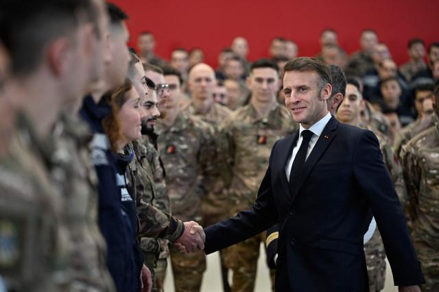 French President Emmanuel Macron shakes hands with soldiers after delivering his New Year's address to the armed forces at the Istres military air force base, southern France, on January 15, 2026. (Photo by Philippe Magoni / POOL / AFP)