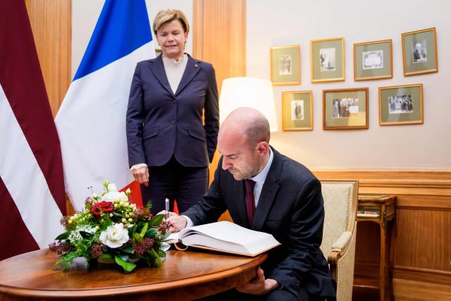France's Foreign Affairs Minister, Minister for Europe Jean-Noel Barrot (R) signs the official guestbook before a meeting Latvian Foreign Minister Baiba Braze (L) at the Ministry of Foreign Affairs in Riga, Latvia, on January 15, 2026. The visit of France's Foreign Affairs Minister, Minister for Europe marks the occasion of the 105th anniversary of de iure recognition of the Republic of Latvia by the international community on January 26, 2026. (Photo by Gints Ivuskans / AFP)