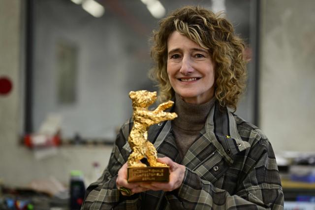 Berlinale director Tricia Tuttle poses with a Golden Bear award during a media event at the production of Berlinale Bear trophies for the upcoming International Film Festival Berlinale at the Hermann Noack fine art foundry's production site in Berlin on January 15, 2026. The Berlinale, running February 13-23, 2025 ranks along with Cannes and Venice among Europe's top film festivals. (Photo by John MACDOUGALL / AFP)