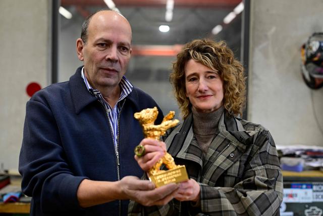 Berlinale director Tricia Tuttle (R) and Noack fine art foundry co-leader Hermann Noack pose with a Golden Bear award during a media event at the production of Berlinale Bear trophies for the upcoming International Film Festival Berlinale at the Hermann Noack fine art foundry's production site in Berlin on January 15, 2026. The Berlinale, running February 13-23, 2025 ranks along with Cannes and Venice among Europe's top film festivals. (Photo by John MACDOUGALL / AFP)