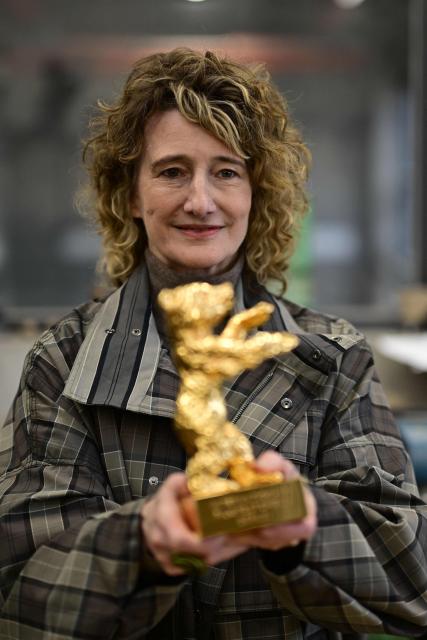 Berlinale director Tricia Tuttle poses with a Golden Bear award during a media event at the production of Berlinale Bear trophies for the upcoming International Film Festival Berlinale at the Hermann Noack fine art foundry's production site in Berlin on January 15, 2026. The Berlinale, running February 13-23, 2025 ranks along with Cannes and Venice among Europe's top film festivals. (Photo by John MACDOUGALL / AFP)