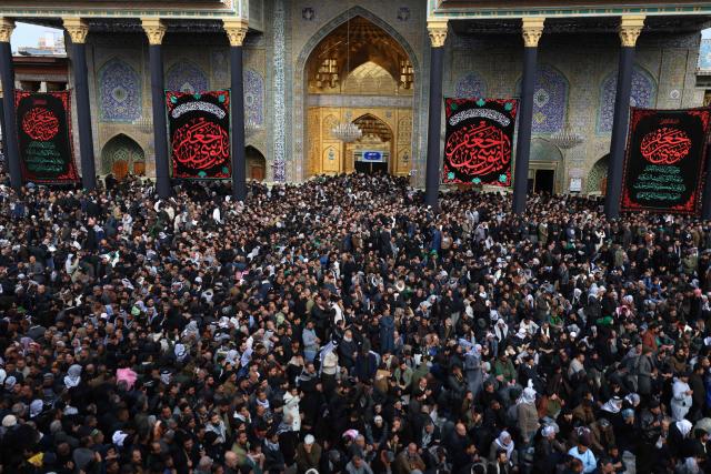 Shiite Muslim pilgrims gather inside the shrine of the 8th-century Imam Musa al-Kadhim, during the annual commemoration of his death on 25 Rajab according to the Muslim Hijri calendar, in the Kadhimiya district of northern Baghdad on January 15, 2026. Pilgrims from various Iraqi provinces annually undertake a march on foot to reach the shrine to commemorate the death of Imam Kadhim, who is believed to have been poisoned by agents of the ruling Abbasid caliph Harun al-Rashid. (Photo by AHMAD AL-RUBAYE / AFP)