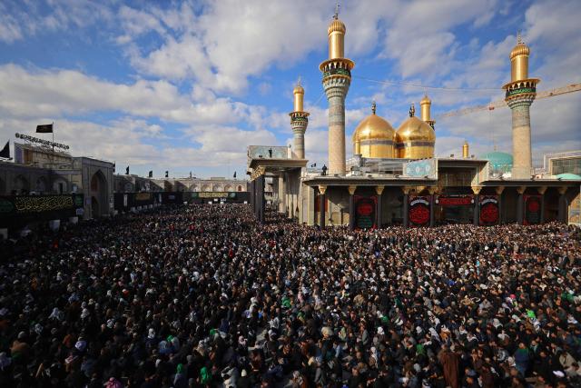 Shiite Muslim pilgrims gather inside the shrine of the 8th-century Imam Musa al-Kadhim, during the annual commemoration of his death on 25 Rajab according to the Muslim Hijri calendar, in the Kadhimiya district of northern Baghdad on January 15, 2026. Pilgrims from various Iraqi provinces annually undertake a march on foot to reach the shrine to commemorate the death of Imam Kadhim, who is believed to have been poisoned by agents of the ruling Abbasid caliph Harun al-Rashid. (Photo by AHMAD AL-RUBAYE / AFP)