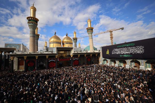 Shiite Muslim pilgrims gather inside the shrine of the 8th-century Imam Musa al-Kadhim, during the annual commemoration of his death on 25 Rajab according to the Muslim Hijri calendar, in the Kadhimiya district of northern Baghdad on January 15, 2026. Pilgrims from various Iraqi provinces annually undertake a march on foot to reach the shrine to commemorate the death of Imam Kadhim, who is believed to have been poisoned by agents of the ruling Abbasid caliph Harun al-Rashid. (Photo by AHMAD AL-RUBAYE / AFP)
