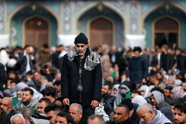 Shiite Muslim pilgrims gather inside the shrine of the 8th-century Imam Musa al-Kadhim, during the annual commemoration of his death on 25 Rajab according to the Muslim Hijri calendar, in the Kadhimiya district of northern Baghdad on January 15, 2026. Pilgrims from various Iraqi provinces annually undertake a march on foot to reach the shrine to commemorate the death of Imam Kadhim, who is believed to have been poisoned by agents of the ruling Abbasid caliph Harun al-Rashid. (Photo by AHMAD AL-RUBAYE / AFP)