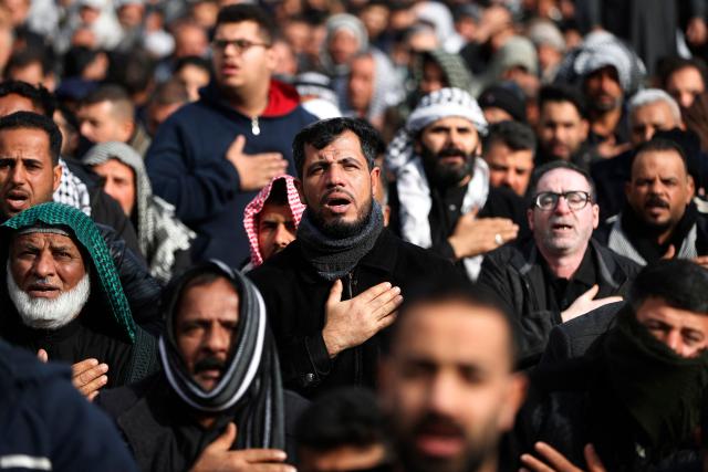 Shiite Muslim pilgrims gather inside the shrine of the 8th-century Imam Musa al-Kadhim, during the annual commemoration of his death on 25 Rajab according to the Muslim Hijri calendar, in the Kadhimiya district of northern Baghdad on January 15, 2026. Pilgrims from various Iraqi provinces annually undertake a march on foot to reach the shrine to commemorate the death of Imam Kadhim, who is believed to have been poisoned by agents of the ruling Abbasid caliph Harun al-Rashid. (Photo by AHMAD AL-RUBAYE / AFP)