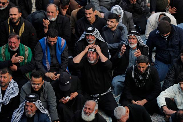Shiite Muslim pilgrims gather inside the shrine of the 8th-century Imam Musa al-Kadhim, during the annual commemoration of his death on 25 Rajab according to the Muslim Hijri calendar, in the Kadhimiya district of northern Baghdad on January 15, 2026. Pilgrims from various Iraqi provinces annually undertake a march on foot to reach the shrine to commemorate the death of Imam Kadhim, who is believed to have been poisoned by agents of the ruling Abbasid caliph Harun al-Rashid. (Photo by AHMAD AL-RUBAYE / AFP)