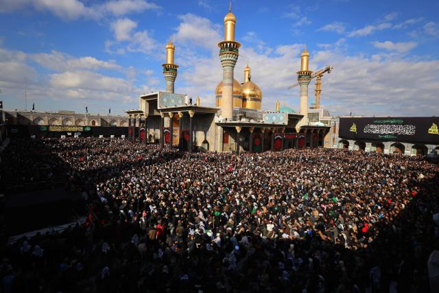 Shiite Muslim pilgrims gather inside the shrine of the 8th-century Imam Musa al-Kadhim, during the annual commemoration of his death on 25 Rajab according to the Muslim Hijri calendar, in the Kadhimiya district of northern Baghdad on January 15, 2026. Pilgrims from various Iraqi provinces annually undertake a march on foot to reach the shrine to commemorate the death of Imam Kadhim, who is believed to have been poisoned by agents of the ruling Abbasid caliph Harun al-Rashid. (Photo by AHMAD AL-RUBAYE / AFP)