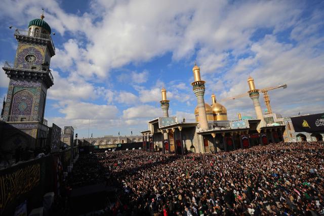 Shiite Muslim pilgrims gather inside the shrine of the 8th-century Imam Musa al-Kadhim, during the annual commemoration of his death on 25 Rajab according to the Muslim Hijri calendar, in the Kadhimiya district of northern Baghdad on January 15, 2026. Pilgrims from various Iraqi provinces annually undertake a march on foot to reach the shrine to commemorate the death of Imam Kadhim, who is believed to have been poisoned by agents of the ruling Abbasid caliph Harun al-Rashid. (Photo by AHMAD AL-RUBAYE / AFP)