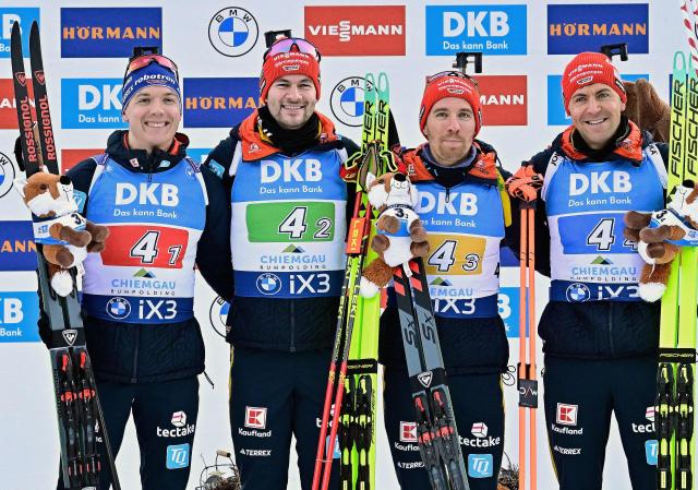 Third placed (L-R) Germany's Justus Strelow, Germany's Danilo Riethmuller, Germany's David Zobel and Germany's Philipp Nawrath celebrate on the podium the men's 4x7,5km relay competition of the IBU Biathlon World Cup in Ruhpolding, southern Germany on January 15, 2026. France won the event ahead of Norway and Germany. (Photo by Tobias SCHWARZ / AFP)