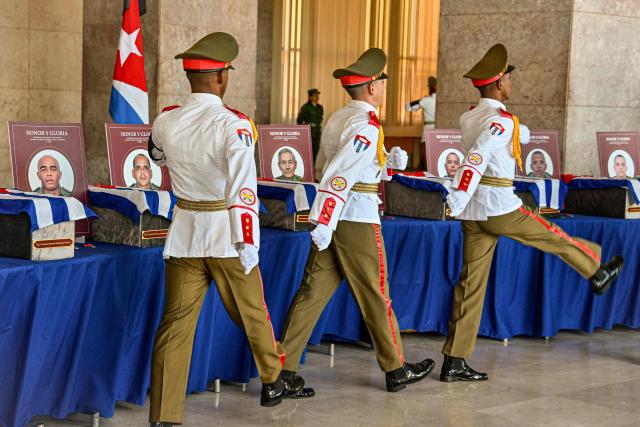 Cuban guards of the Ceremonial Battalion march in front of the urns with the remains of the 32 Cuban soldiers who died during the US incursion to capture Venezuelan leader Nicolas Maduro, during the funeral honors at the Ministry of the Revolutionary Armed Forces in Havana on January 15, 2026. The capture by US forces of Venezuelan leader Nicolas Maduro on January 3, 2026, and the killing in the operation of 32 Cubans assigned to protect him represent a major blow for the island's revered intelligence services, experts say. (Photo by ADALBERTO ROQUE / POOL / AFP)