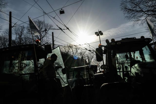 A farmer leaves his tractor parked in a street of Lyon during a protest against the EU-Mercosur trade deal in Lyon on January 15, 2026. (Photo by JEFF PACHOUD / AFP)