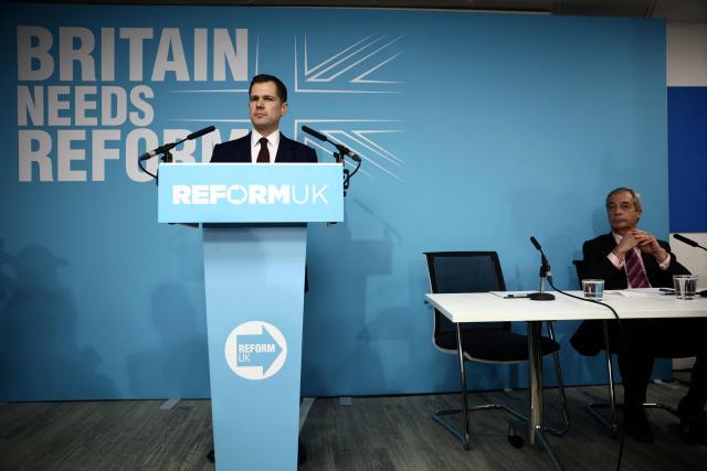 Britain's former Conservative Party Shadow Justice Secretary Robert Jenrick looks on beside Reform UK leader, Nigel Farage during a press conference to announce his defection to Reform, in central London on January 15, 2026. (Photo by Henry NICHOLLS / AFP)