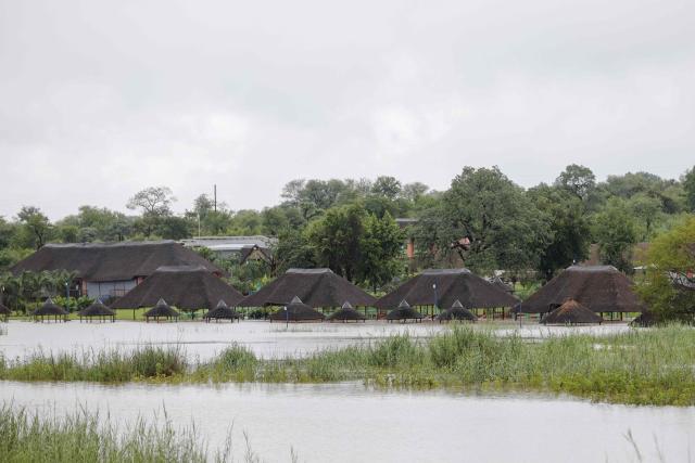 TOPSHOT - A general view floodwaters at Axivaleni Resort at the Nsami dam, in Giyani on January 15, 2026. Flooding triggered by torrential rains in northeastern South Africa claimed at least 10 lives overnight and forced the closure of the iconic Kruger National Park, officials said on January 15, 2026. 
The weather service issued the maximum warning for more rain in parts of the country while neighbouring Mozambique was also on alert after flooding that inundated roads and homes. (Photo by Orlando Chauke / AFP)