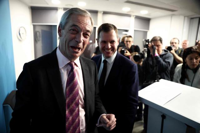 Britain's former Conservative Party Shadow Justice Secretary Robert Jenrick reacts with Reform UK leader, Nigel Farage, after announcing his defection to Reform, during a press conference, in central London on January 15, 2026. (Photo by Henry NICHOLLS / AFP)