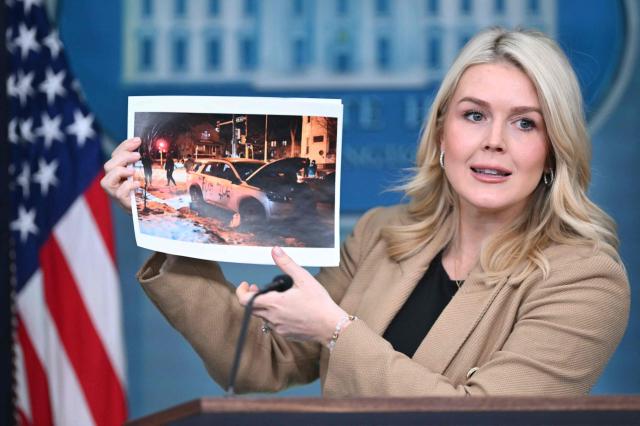 White House Press Secretary Karoline Leavitt holds up a picture of allgedly vandalized Immigration and Customs Enforcement (ICE) vehicles in Minnesota as she speaks during a press briefing in the Brady Briefing Room of the White House in Washington, DC, on January 15, 2026. (Photo by Mandel NGAN / AFP)