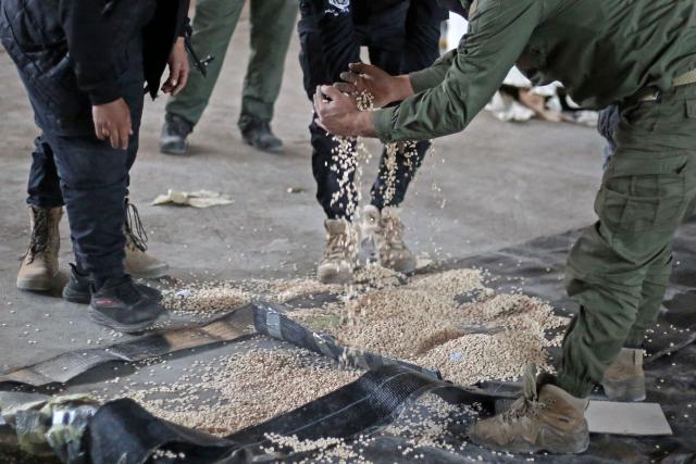 (FILES) Members of the security forces with Syria's new government inspect a warehouse that was used to hide pills of Captagon, a brand name of the psychostimulant drug Fenethylline, inside children's toys, hookahs, house doors and plastic insulation, during a raid in Latakia on January 19, 2025. Anti-narcotics authorities from Syria and Iraq have seized 2.5 million captagon stimulant pills after carrying out raids in both countries, Syria's interior ministry said on Januray 15, 2026. Two people were arrested in Syria and one in Iraq in the joint operations, the ministry said in a statement. (Photo by AAREF WATAD / AFP)