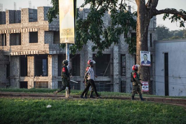Ugandan military police officers detain a voter near a polling station in Kampala on January 15, 2026, during Uganda's 2026 general elections. Polls closed in Uganda on January 15, 2026 after a chaotic day of voting that took place under an internet blackout and with long delays caused by technical breakdowns as President Yoweri Museveni seeks to extend his 40 years in power. Museveni, an 81-year-old who came to power at the head of a rebel army in 1986, is widely expected to win a seventh term in office thanks to his total control of the state and security apparatus. (Photo by BADRU KATUMBA / AFP)