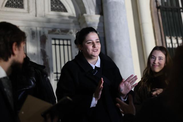 Syrian competitive swimmer and activist Sarah Mardini reacts as she exits the courthouse in Mytilene on January 15, 2026. A Greek court on January 15 acquitted Sarah Mardini, whose rescue of her sister inspired a hit Netflix film, and 23 others of migrant trafficking. The verdict came almost a month after the start of their trial at a court on Lesbos, ending a legal ordeal for the activists since 2018. (Photo by Manolis LAGOUTARIS / AFP)