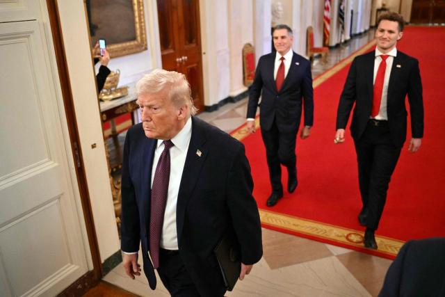 US President Donald Trump (L) enters the East Room to attend a ceremony with the Florida Panthers of the National Hockey League, winners of the 2025 Stanley Cup, in the White House in Washington, DC on January 15, 2026. (Photo by Mandel NGAN / AFP)