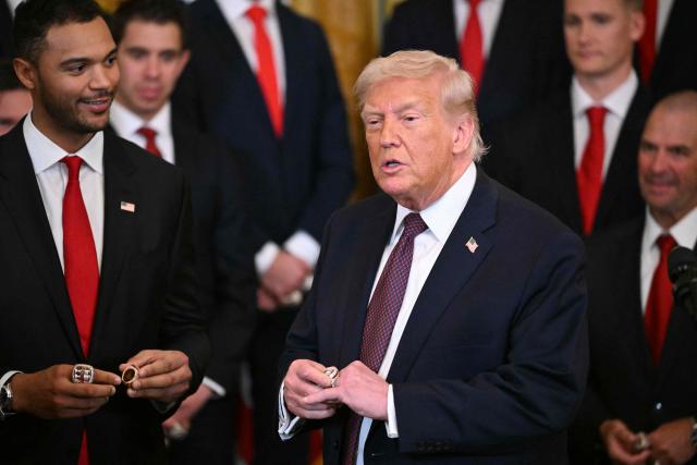US President Donald Trump tries a champions ring during a congratulatory ceremony with the Florida Panthers of the National Hockey League, winners of the 2025 Stanley Cup, in the East Room of the White House in Washington, DC on January 15, 2026. (Photo by Mandel NGAN / AFP)