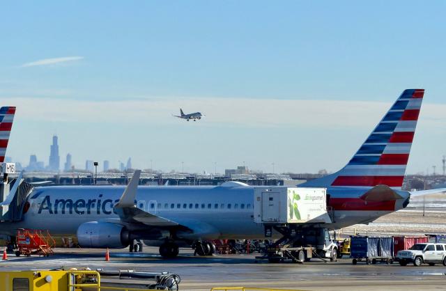 An American Airlines sits at a gate at Chicago O'Hare International Airport in the northwest side of Chicago, Illinois on January 15, 2026. (Photo by Daniel SLIM / AFP)