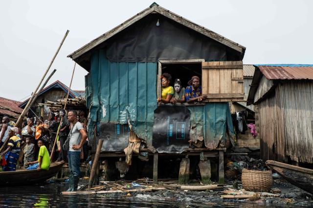 Residents look on during demolition of houses in Makoko, a floating slum in Lagos, on January 9, 2026. Authorities have demolished hundreds of wooden shacks in Makoko, Africa’s largest and most iconic floating slum, which is built on stilts above the lagoon in the heart of Lagos. The operation is part of an ongoing campaign to remove what officials describe as illegal structures and reclaim waterfront land for modern real-estate developments. (Photo by TOYIN ADEDOKUN / AFP)