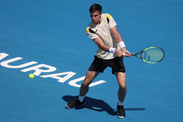 Fabian Marozsan of Hungary hits a return against Jakub Mensik of the Czech Republic during their men's singles semi-final match at the ATP Auckland Classic tennis tournament in Auckland on January 16, 2026. (Photo by Michael Bradley / AFP)