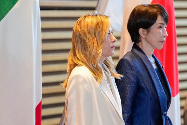 Italy's Prime Minister Giorgia Meloni (L) and Japan's Prime Minister Sanae Takaichi inspect honour guards at the prime minister's official residence in Tokyo on January 16, 2026. (Photo by Toru HANAI / POOL / AFP)