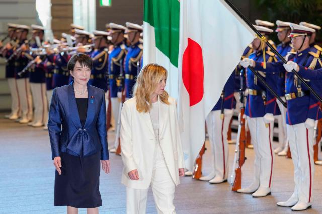 Italy's Prime Minister Giorgia Meloni (R) and Japan's Prime Minister Sanae Takaichi inspect honour guards at the prime minister's official residence in Tokyo on January 16, 2026. (Photo by Toru HANAI / POOL / AFP)