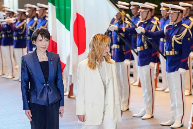 Italy's Prime Minister Giorgia Meloni (R) and Japan's Prime Minister Sanae Takaichi inspect honour guards at the prime minister's official residence in Tokyo on January 16, 2026. (Photo by Toru HANAI / POOL / AFP)