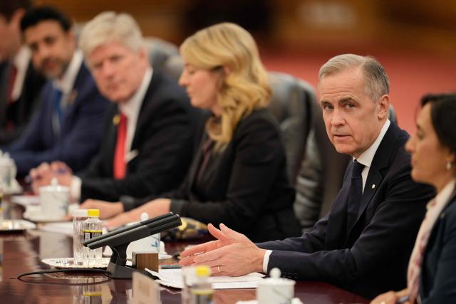 Canada's Prime Minister Mark Carney (2nd R) speaks during a meeting with Chinese President Xi Jinping at the Great Hall of the People in Beijing on January 16, 2026. (Photo by Vincent Thian / POOL / AFP)