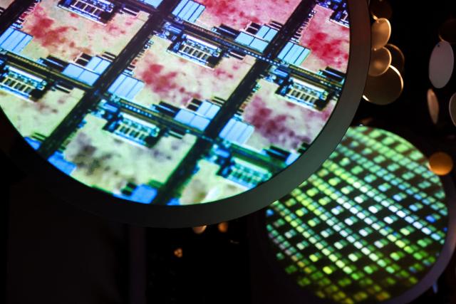 (FILES) An image of an electronic wafer is displayed at the Taiwan Semiconductor Manufacturing Company (TSMC) Museum of Innovation in Hsinchu on November 21, 2024. Taiwan said on January 16, 2026 it will remain the world's "most important" producer of AI semiconductor chips, after reaching a trade deal with the United States that will see Taiwanese companies increase investment on US soil. (Photo by I-Hwa CHENG / AFP)