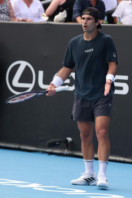 USA's Marcos Giron reacts after a point against Argentina's Sebastian Baez during their men's singles semi-final match at the ATP Auckland Classic tennis tournament in Auckland on January 16, 2026. (Photo by Michael Bradley / AFP)